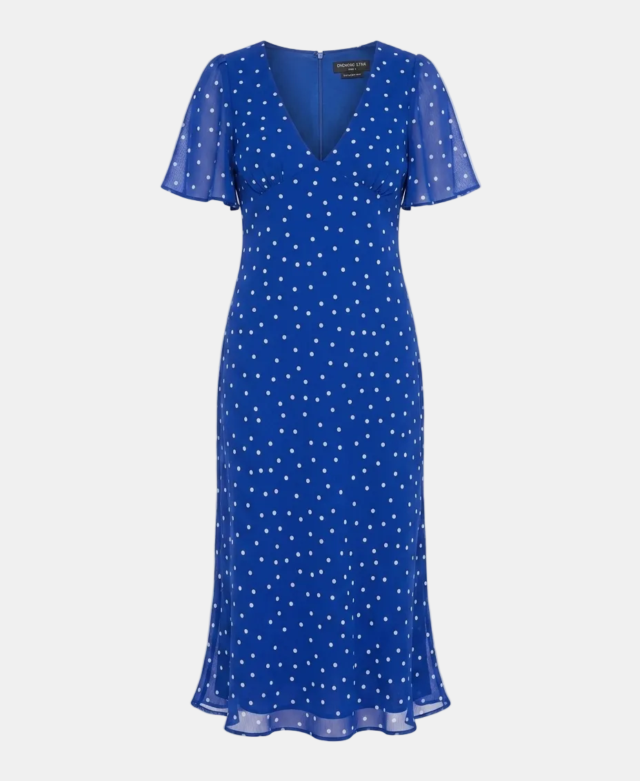 A royal blue midi-length wrap dress with white polka dots, featuring short flutter sleeves and a V-neckline, shown on a light gray background.