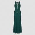 A sleeveless, floor-length dark green evening gown with a deep V-neckline, embellished with sparkling sequins and beadwork, and a sheer mesh overlay, shown against a light gray background.
