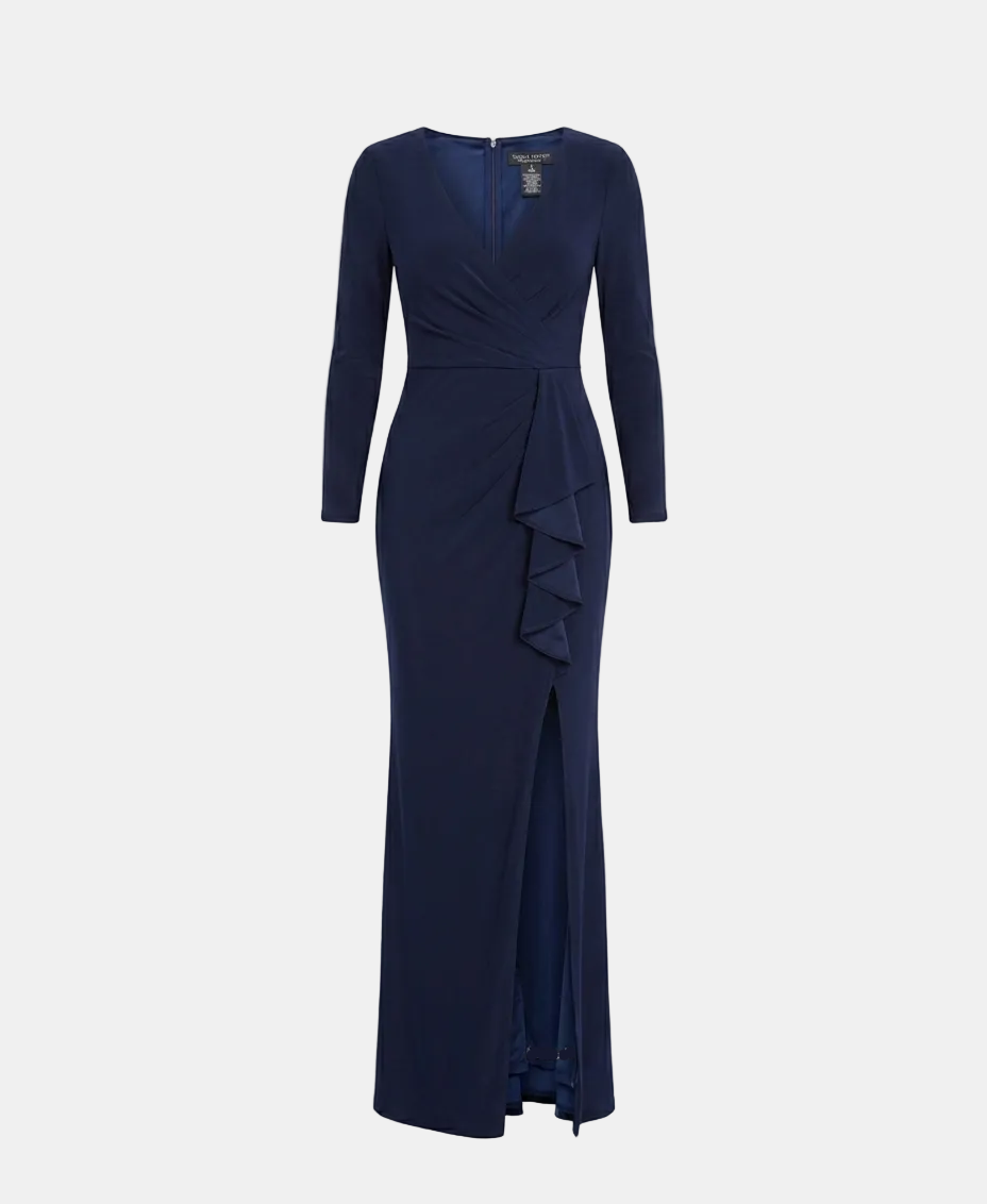 A navy blue long-sleeve maxi dress with a wrap-style V-neckline, ruffled detailing at the waist, and a front slit, shown on a light gray background.