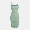 A sage green ruched spaghetti-strap mini dress shown on a ghost mannequin against a light gray background.